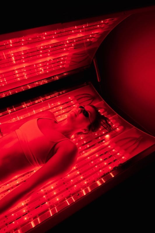 Person receiving full-body LED light therapy